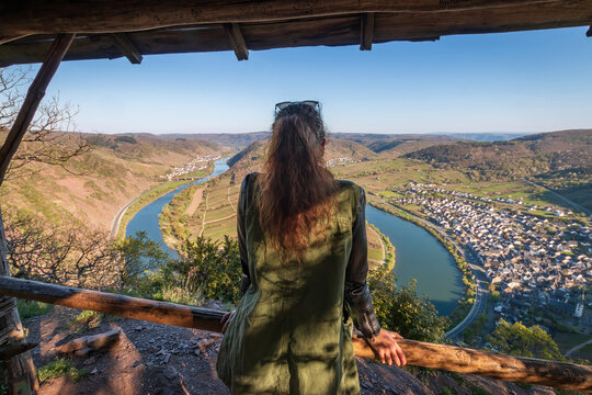 Woman at scenic view from Calmont hiking trail to Moselle loop (germ. Moselschleife), Germany