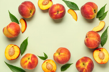 Frame made of sweet peaches and leaves on light background
