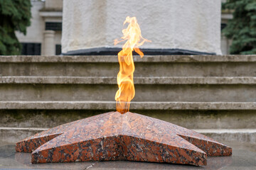 Eternal flame. A traditional monument to those who died in the war. Background