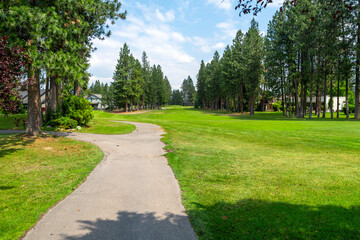 Fototapeta na wymiar Manicured fairways, greens and hazards at a suburban golf course, part of a luxury golf community of homes in the rural town of Post Falls, Idaho, in the general Coeur d'Alene area of North Idaho. 