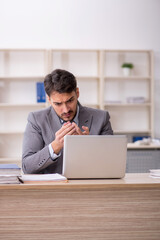 Young male employee working in the office
