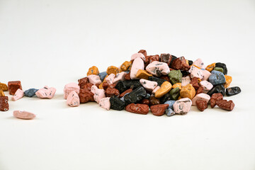 Colorful chocolate candy stones background on a White Background