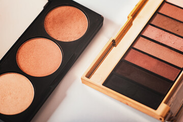 decorative cosmetics, eyeshadow palettes and cosmetic brush close-up on a white background, top...