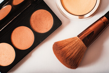 decorative cosmetics, shadow palette and cosmetic brush close-up on a white background, top view. Macro. Makeup