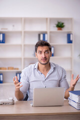 Young male employee working in the office