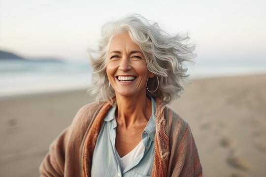 Smiling Attractive Beautiful Caucasian Senior Mature Woman Posing At The Beach Looking At The Camera