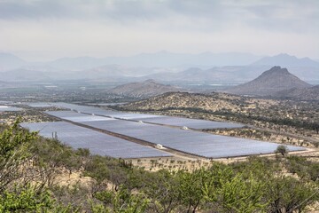 Photo of a vast field with a prominent solar panel harnessing renewable energy in Quilapilun, Chile