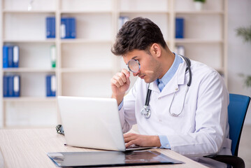 Young male doctor in telemedicine concept