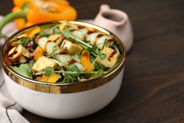 Delicious salad with tofu, vegetables and balsamic vinegar on wooden table, closeup. Space for text