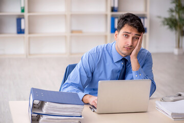 Young male employee working in the office