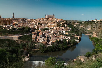 Fototapeta na wymiar Panoramic landscape with beautiful blue sky and view of the Tagus river in the city of Toledo, Spain.