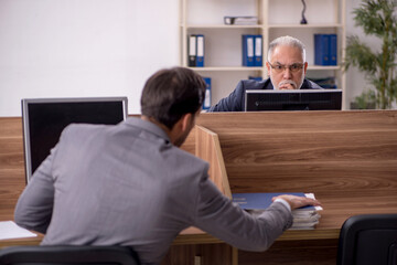 Two male colleagues working in the office