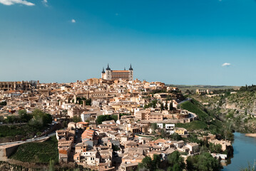 Fototapeta na wymiar Panoramic landscape with beautiful blue sky and view of the Tagus river in the city of Toledo, Spain.