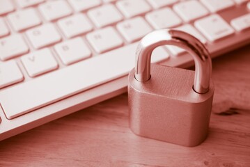 Padlock on computer keyboard background in monochrome tone. Encryption username password in online internet website, cyber security, privacy data information protection, firewall concept.