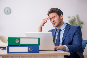 Young male employee working in the office