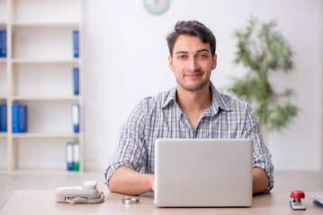 Young male employee working in the office