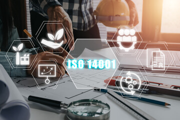 ISO 14001 certified environmental management systems concept, Engineer team working on office desk...