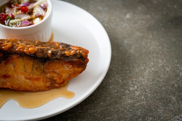 fried snapper fish with fish sauce and spicy salad