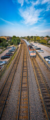 Vertical panoramic view of train in downtown Wheaton, Illinois, USA. June, 2023.