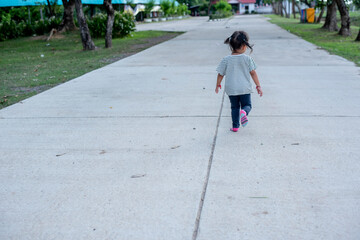 Asian girl running in the park happily.