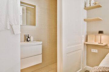 a bathroom with a sink and mirror on the wall next to the toilet in the photo is taken from the door