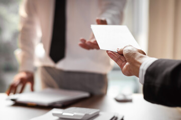 Worried businessman receiving a notification from a colleague in her workplace at office. Fired from job concept.