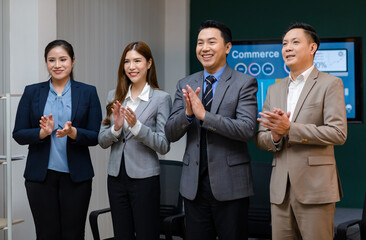 Millennial Asian professional successful male female businessmen businesswomen group in formal business suit standing together showing teamwork union unity in meeting room