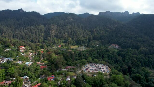 backwards drone shot of mineral del chico town in Hidalgo Mexico and sorrounding forest