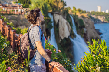 Man tourist on the background of Duden waterfall in Antalya. Famous places of Turkey. Lower Duden...