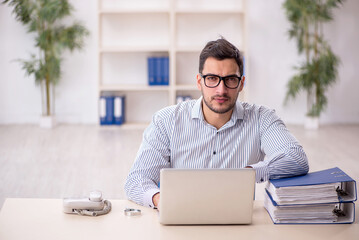 Young male employee working in the office