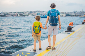 Boy and father tourists enjoying Galataport area view, cruise port of Istanbul newly opening in 2021, located in the shores of the Galata, Karakoy in Istanbul. Traveling with kids concept