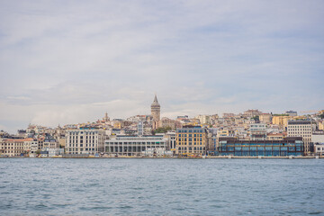Fototapeta na wymiar Istanbul city skyline in Turkey, Beyoglu district old houses with Galata tower on top, view from the Golden Horn