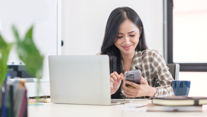 Beautiful businesswoman checking message on smartphone. Communication, connection, technology,...