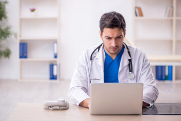 Young male doctor working in the clinic