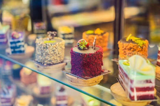 Different types of cakes in pastry shop glass display