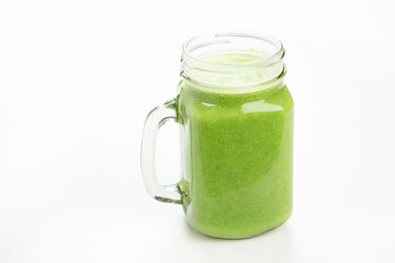 Healthy green smoothie  in a jar mug  on white background