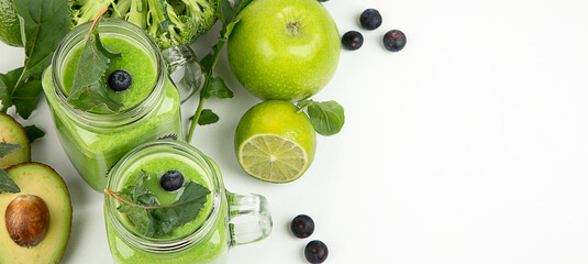 Healthy green smoothie  in a jar mug  on white background