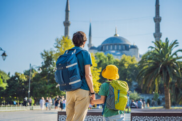 Fototapeta na wymiar father and son tourists enjoying the view Blue Mosque, Sultanahmet Camii, Istanbul, Turkey. Traveling with kids concept