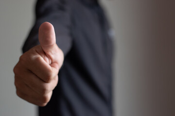 Image of businessman hand raising thumb showing excellence in work