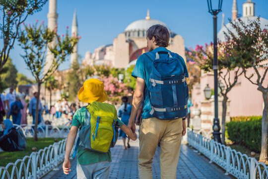 Father and son Tourists enjoy beautiful view on Hagia Sophia Cathedral, famous islamic Landmark mosque, Travel to Istanbul, Turkey. Traveling with kids concept. Sunny day architecture and Hagia Sophia