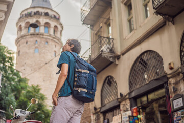 Portrait of man tourist with view of Galata tower in Beyoglu, Istanbul, Turkey. Turkiye