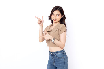 portrait of a Happy Asian woman smiling points her index finger at an empty space in the background and looks straight ahead on white background