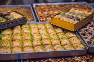 Traditional oriental sweet pastry cookies, nuts, dried fruits, pastilles, marmalade, Turkish desert with sugar, honey and pistachio, in display at a street food market