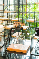 Coffee brewing gadgets on wooden bar counter in coffee shop.