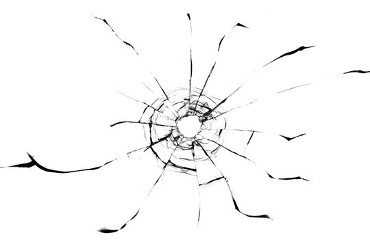 Texture of glass cracks from a gun shot. Bullet hole in window, isolated texture on white background