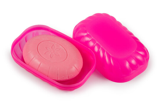 Pink plastic soap dish on a white background. Toilet soap in a plastic soap dish.