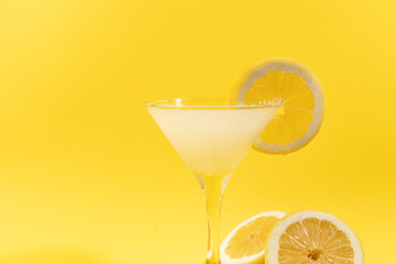 Fresh lemonade with lemon on yellow background