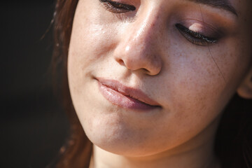 Close-up portrait of a beautiful young woman with eyes closed