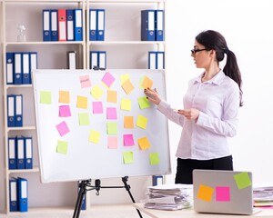 Young female employee in conflicting priorities concept