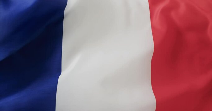 White rugby ball rolling over waving flag of france with copy space, in slow motion